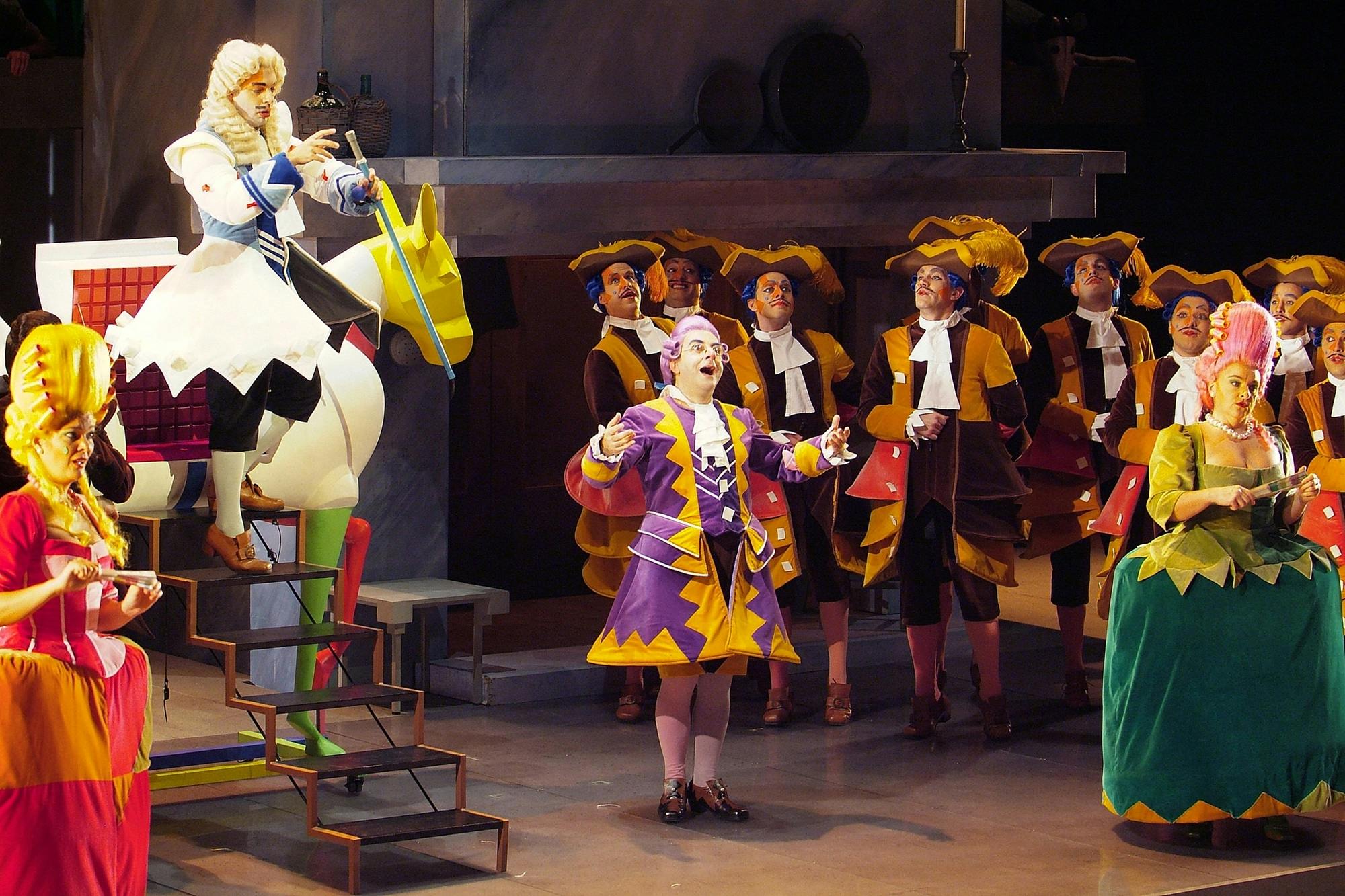 A performer speaking on stage to a crowd, along with a performer stepping down stairs from a horse-drawn carriage