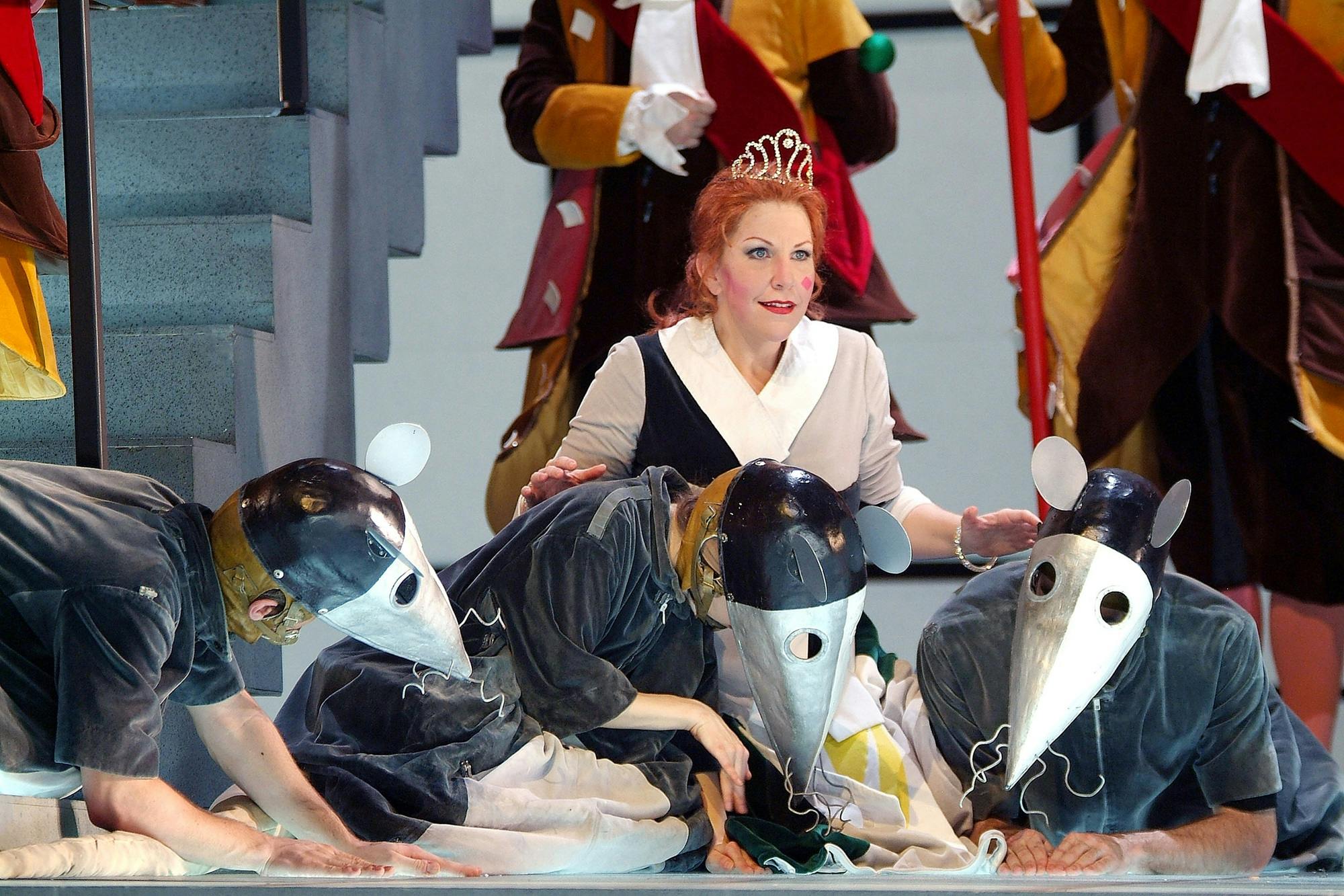Joyce DiDonato kneeling next to performers dressed in rodent costumes