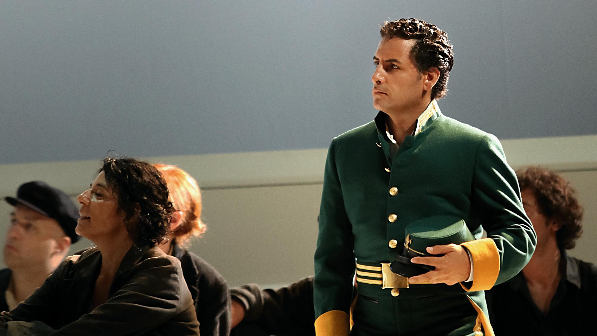 Juan Diego Flórez standing and holding a hat.