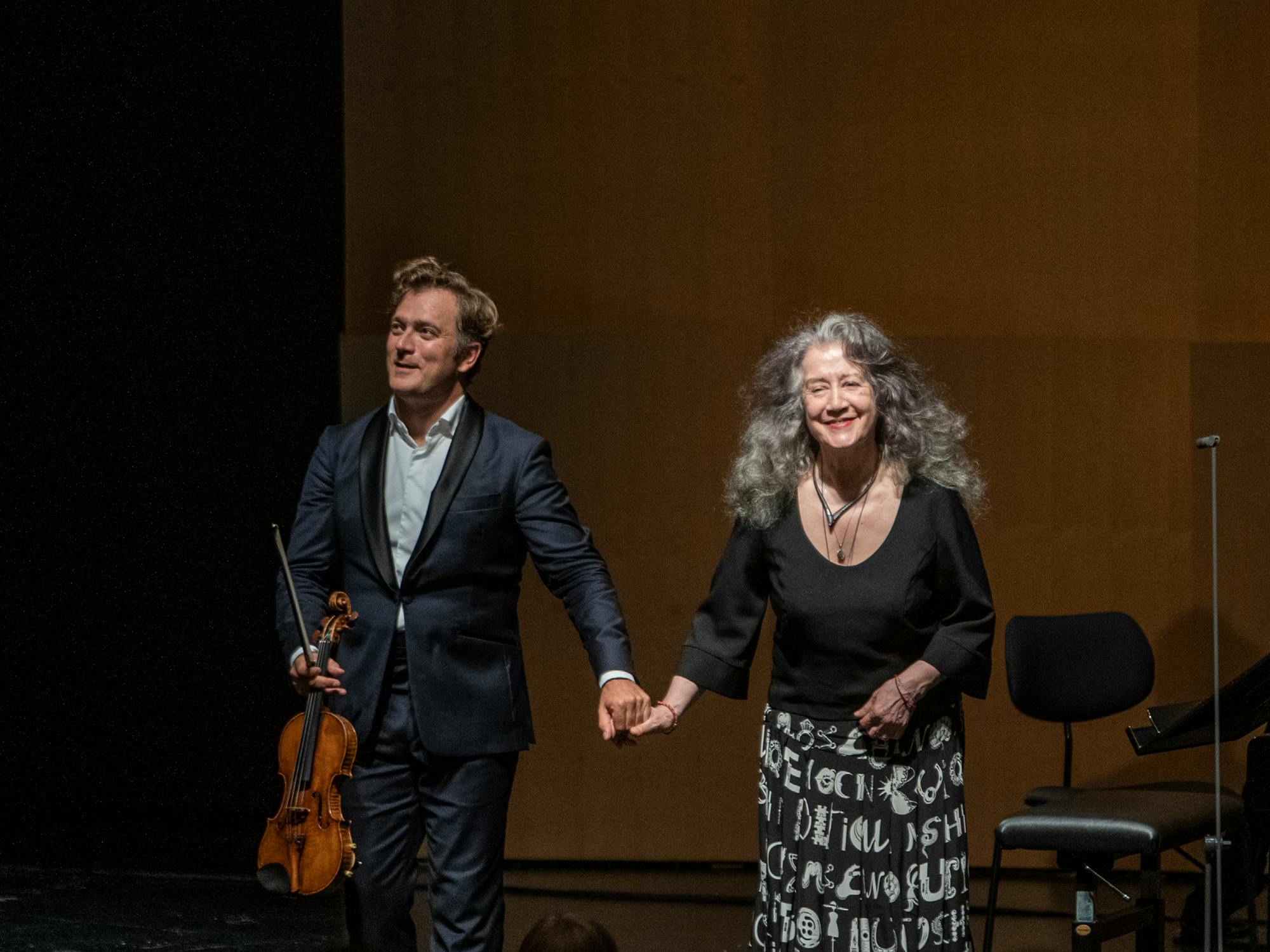 Renaud Capuçon and Martha Argerich standing for applause.