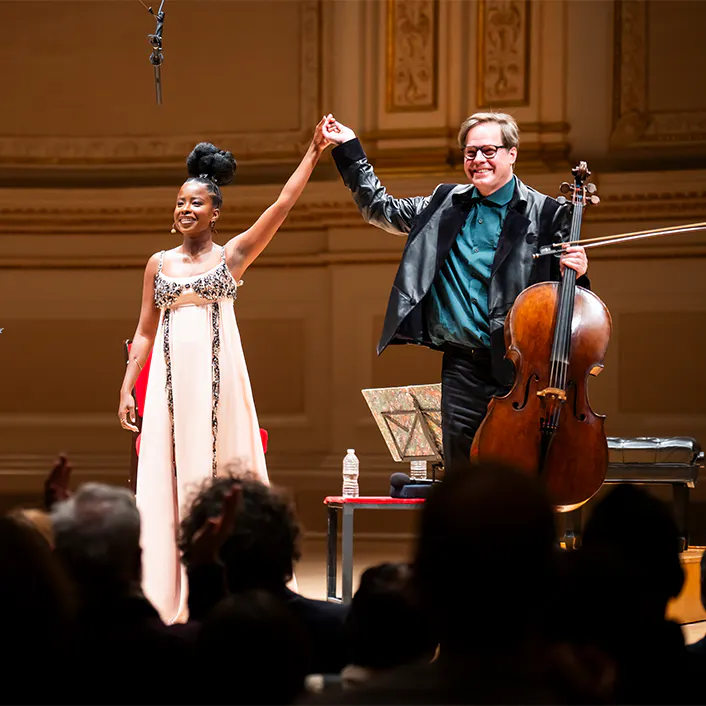 Amanda Gorman and Jan Vogler standing on stage for applause.