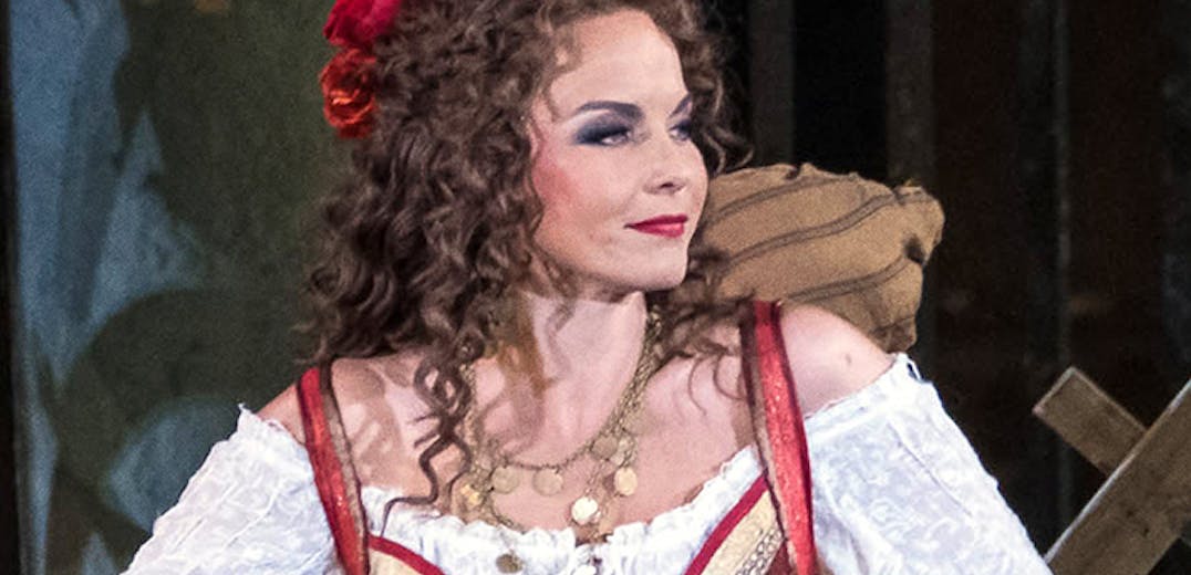 A performer in a red and white dress, and another performer on stage