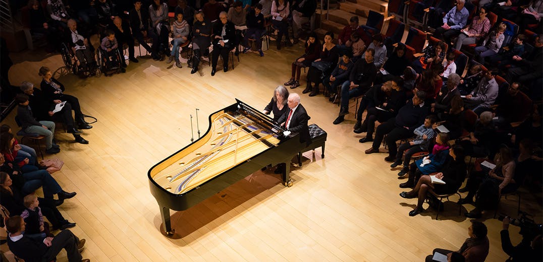 Martha Argerich and Daniel Barenboim sitting at the piano