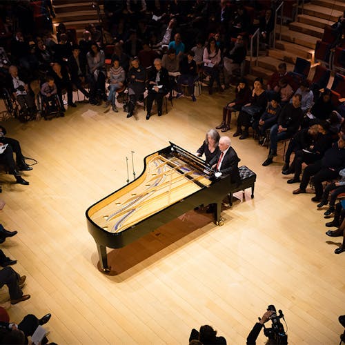 Martha Argerich and Daniel Barenboim sitting at the piano