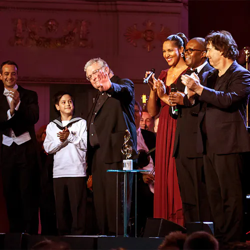 Guest soloists applauding on stage, and Randy Newman waving to the crowd