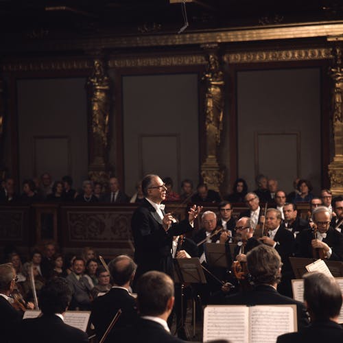 A conductor conducting an orchestra