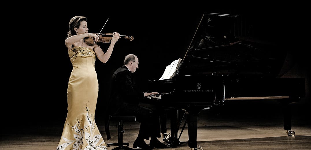 Anne-Sophie Mutter and Lambert Orkis playing violin and piano on stage.