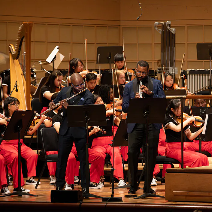 Demarre McGill and Titus Underwood performing with members of NYO2 on stage