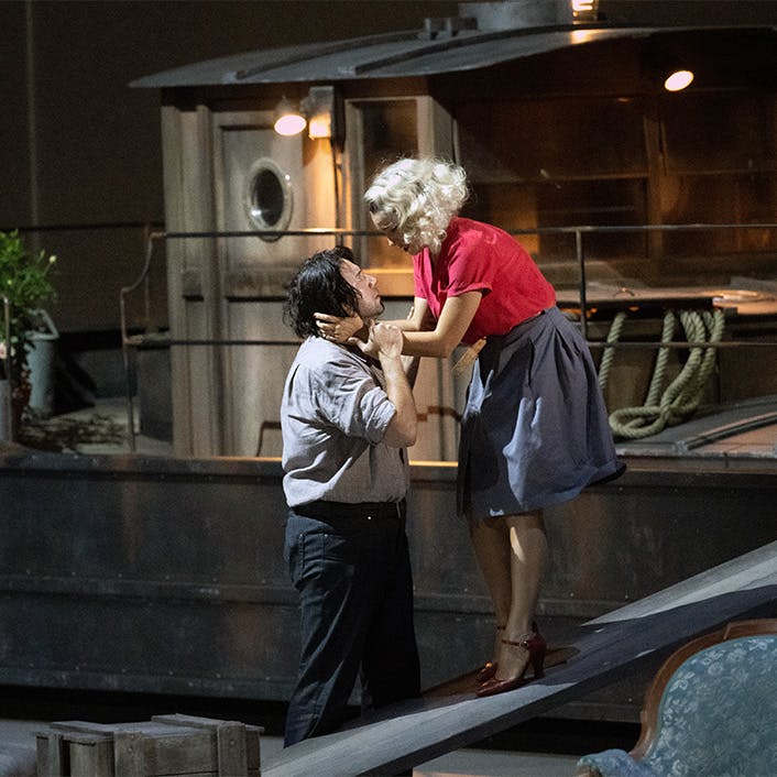 Two people standing and holding one another