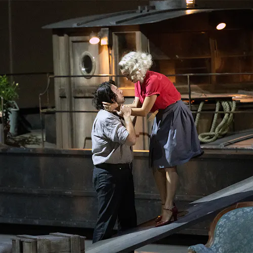 Two people standing and holding one another