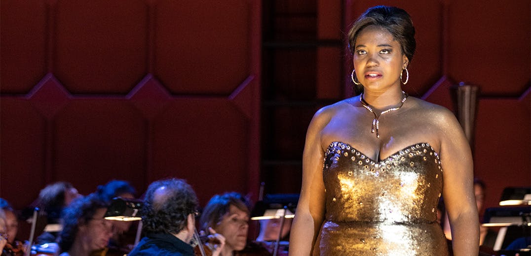 Angel Blue on stage with members of an orchestra