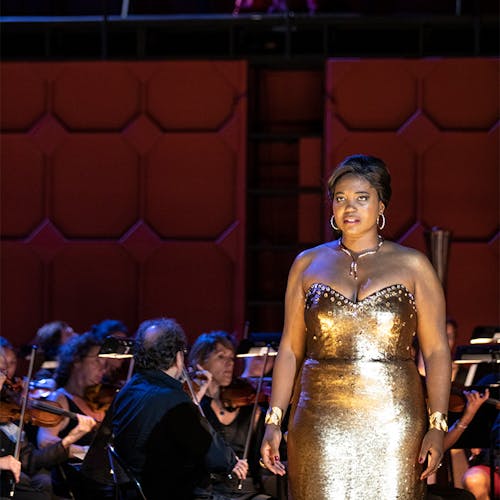 Angel Blue on stage with members of an orchestra