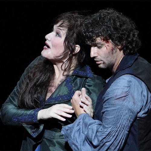 An actor looking up and another actor holding them