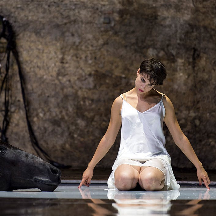 Asmik Grigorian kneeling on the ground