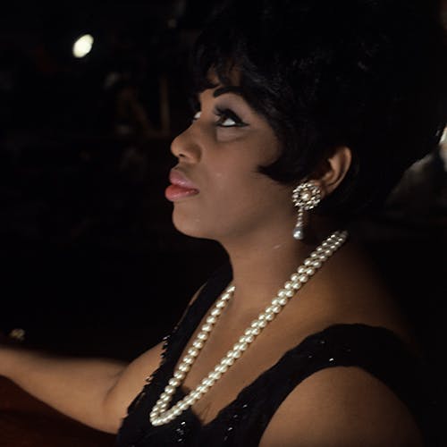 Leontyne Price standing with a mirror behind her