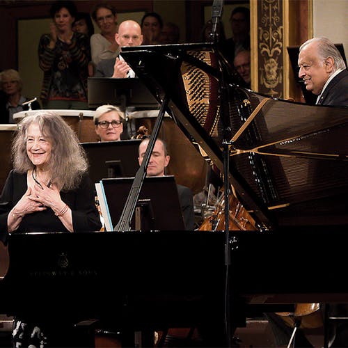 Martha Argerich, Zubin Mehta, and the Vienna Philharmonic standing on stage