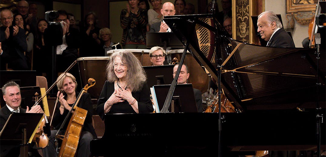 Martha Argerich, Zubin Mehta, and the Vienna Philharmonic standing on stage