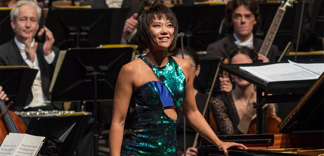 Yuja Wang standing in front of an orchestra