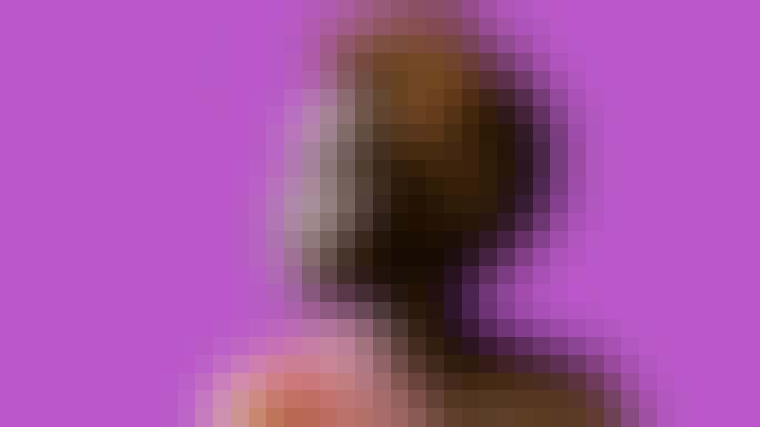 Imani Uzuri against a purple background